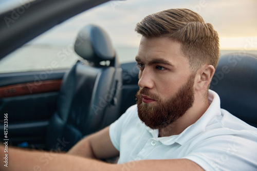 Young european man riding in cabriolet automobile © Drobot Dean