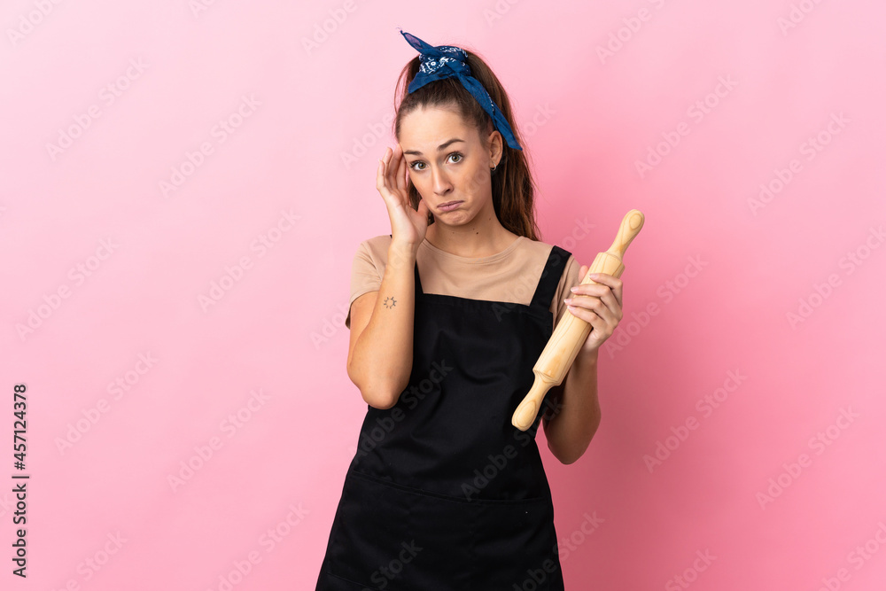 Young woman holding a rolling pin thinking an idea Young woman holding a rolling pin thinking an idea