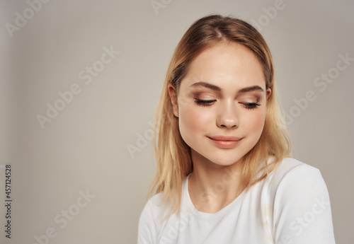 pretty blonde woman in t-shirt bright makeup close-up