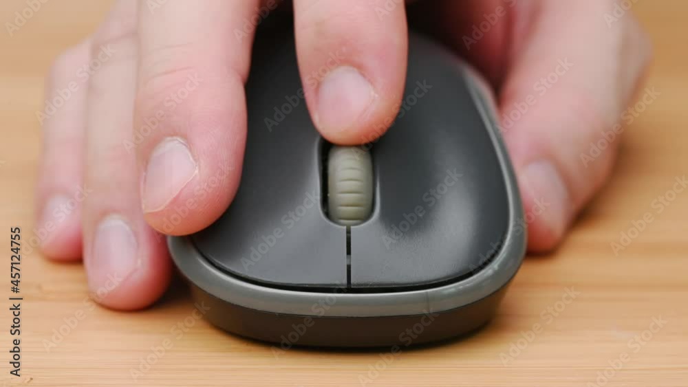 Clicking digital wireless mouse and working on computer at the office ...