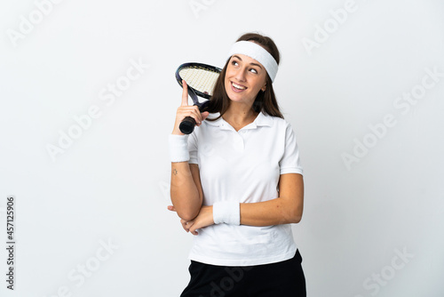 Young woman tennis player over isolated white background pointing up a great idea © luismolinero