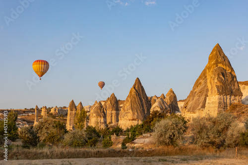 Cappadocia, Turkey - September 1, 2021 - Cappadocia Panoramic - Hot air balloon flying in early morning over rock landscape at Cappadocia Turkey