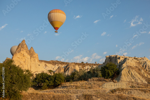 Cappadocia, Turkey - September 1, 2021 - Cappadocia Panoramic - Hot air balloon flying in early morning over rock landscape at Cappadocia Turkey © Deyan