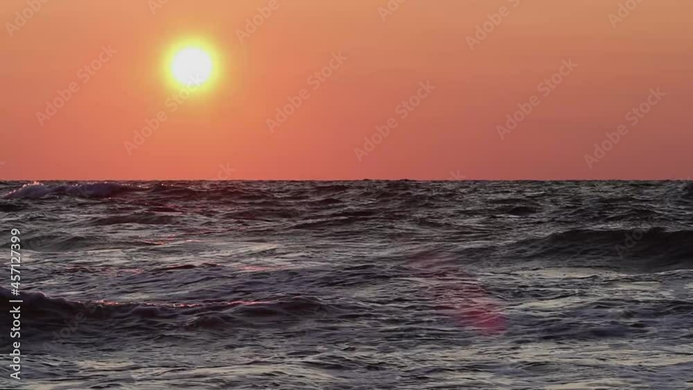 A Waved Sea In The Rays Of Sunset. A Fiery Sun And An Orange Sky A Waved Sea In The Rays Of Sunset. A Fiery Sun And An Orange Sky