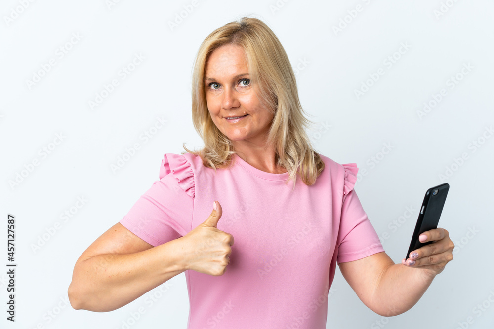 Middle age using mobile phone isolated on white background with thumbs up because something good has happened Middle age using mobile phone isolated on white background with thumbs up because something good has happened
