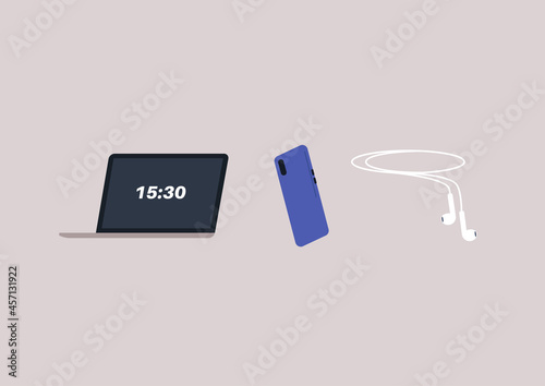 A set of electronic gadgets, a laptop, a mobile phone, and earphones