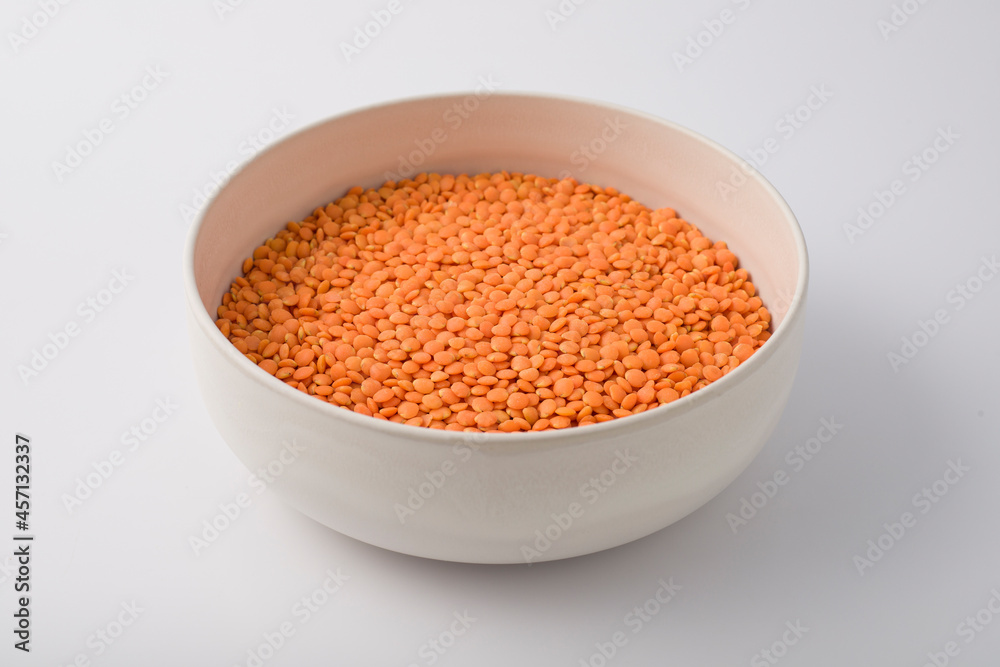Red or Pink Lentils on round large white plate. isolated on white Red or Pink Lentils on round large white plate. isolated on white