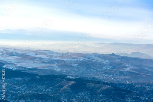 Fototapeta Naklejka Na Ścianę i Meble -  Kislovodsk, Russia. December 28, 2018. Evening view from a high mountain to the mountains and forest of Kislovodsk.