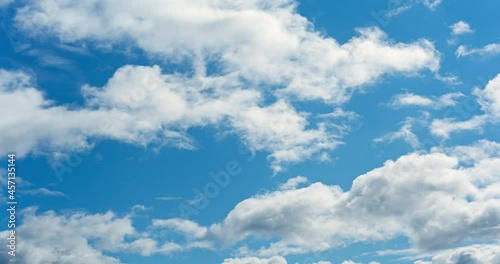 White fluffy clouds on blue sky. Beautiful sunny time lapse. Great summer travel texture. Moving timelapse.