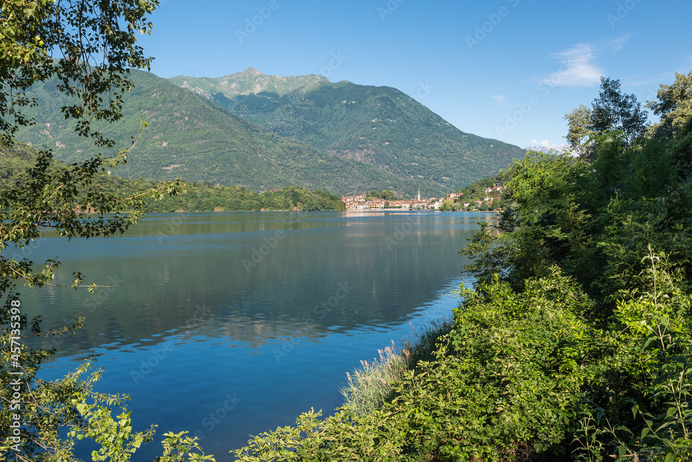 Beautiful Italian bathing lake with clear waters. Lake Mergozzo with in the background the town of Mergozzo, valle Ossola. Province of Verbano Cusio Ossola in Piedmont region, Italy