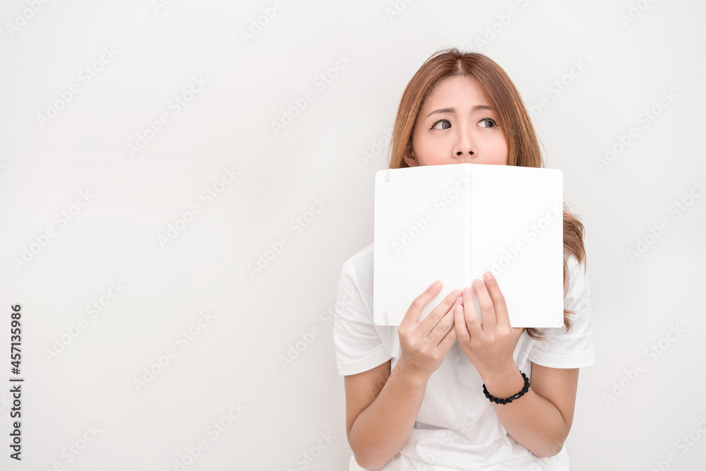 Young attractive asian student holding books in her arm on white background. School girl with a books to read for homework. Young attractive asian student holding books in her arm on white background. School girl with a books to read for homework.
