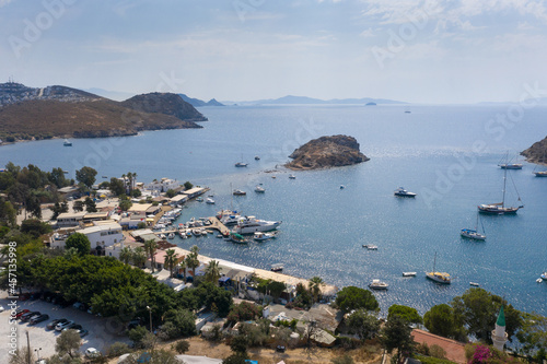 Fototapeta Naklejka Na Ścianę i Meble -  Aerial view of Bodrum's well-known holiday resort Gumusluk (Gümüşlük) bay and boats in the sea. TURKEY
