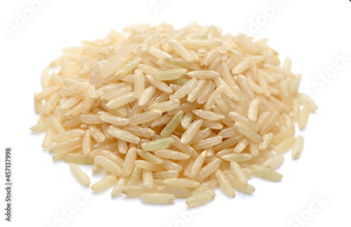 close up of uncooked long brown rice isolated on white