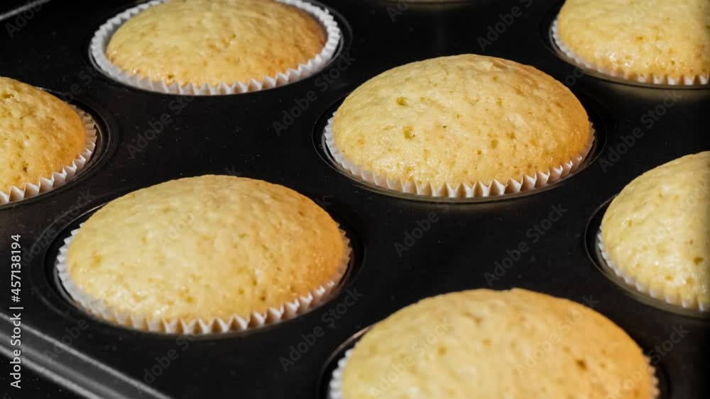Timelapse - cupcakes, muffins baking and rising in muffin tin in electric oven in kitchen at home - close up view. Homemade bakery, food, cooking, pastry and time lapse concept Timelapse - cupcakes, muffins baking and rising in muffin tin in electric oven in kitchen at home - close up view. Homemade bakery, food, cooking, pastry and time lapse concept
