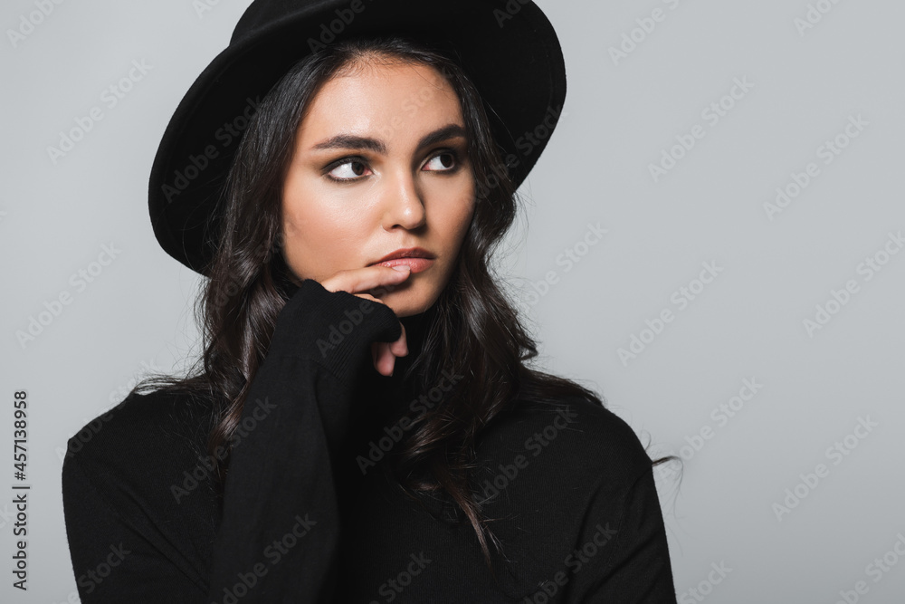 dreamy young model in black fedora hat and turtleneck looking away isolated on grey dreamy young model in black fedora hat and turtleneck looking away isolated on grey