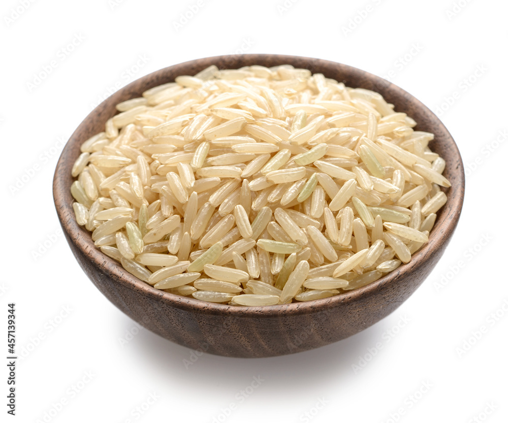 uncooked brown rice in the wooden bowl, isolated on the white background