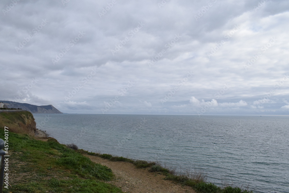 View of the Black Sea, beach and mountains. The resort town of Anapa. Russia. Photo taken in spring. View of the Black Sea, beach and mountains. The resort town of Anapa. Russia. Photo taken in spring.