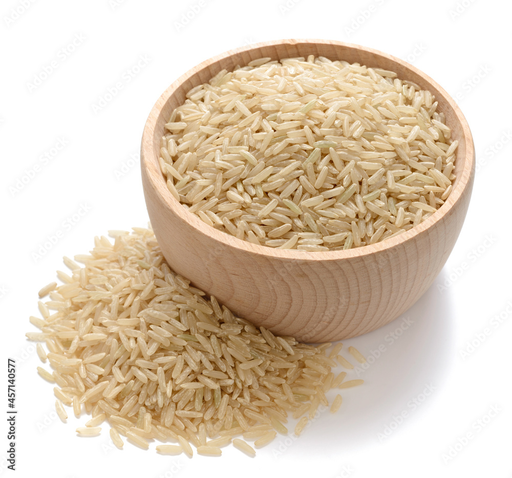 uncooked long brown rice in the wooden bowl, isolated on the white background