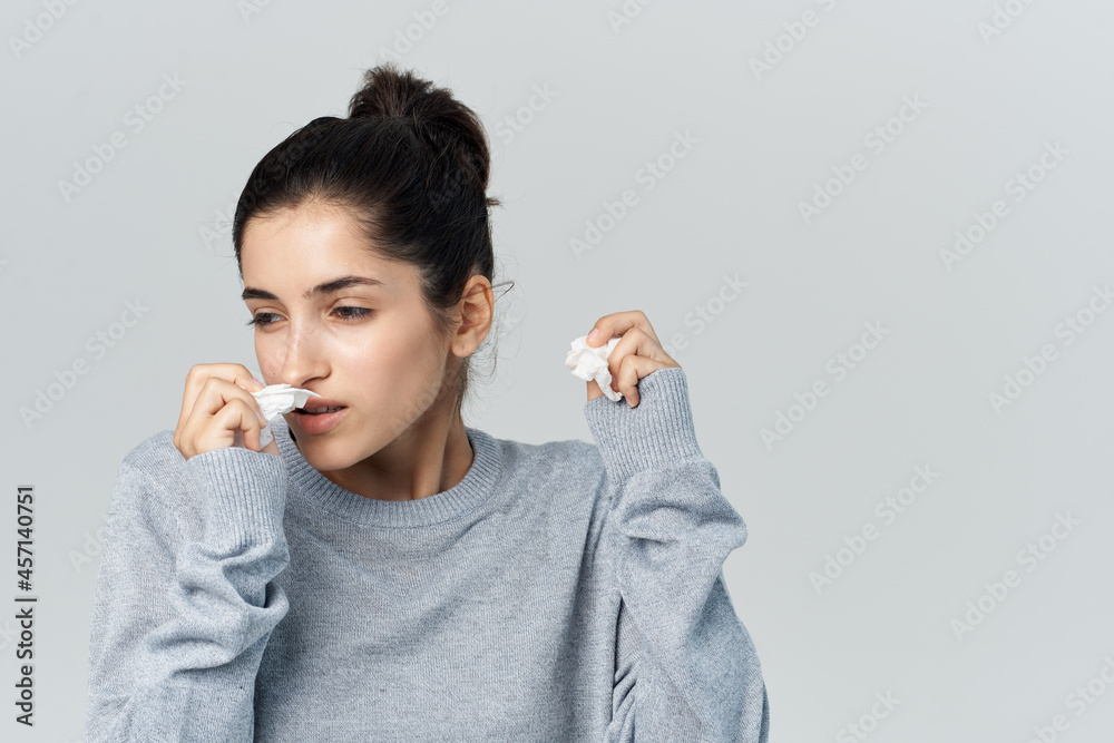 sick woman on wipes her nose health problems light background sick woman on wipes her nose health problems light background