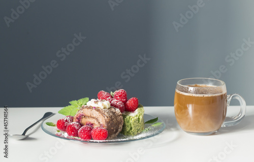 cup of coffee and dessert with raspberries on white table on background blue ...