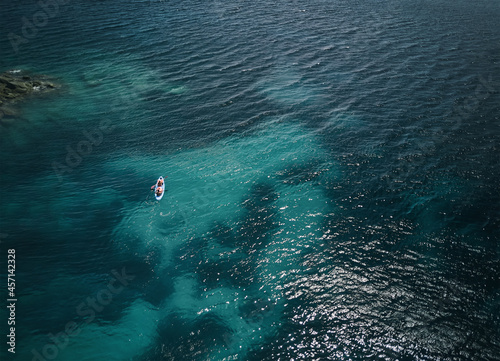 Wallpaper Mural aerial view of kayaking in the ocean - activity sport in the shoreline of south Sardinia - summer season