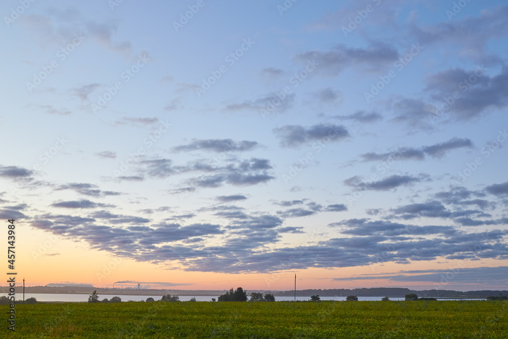 Obraz premium sunrise over a reservoir with a potash factory in the background