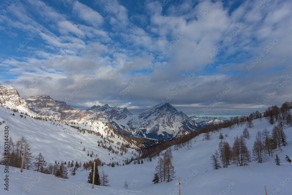 Winter sunset panorama with cloudy sky on Mount Sorapiss and Mount Antelao. San Vito di Cadore, Dolomites, Italy