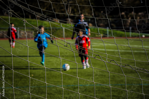 Young soccer player kicking ball