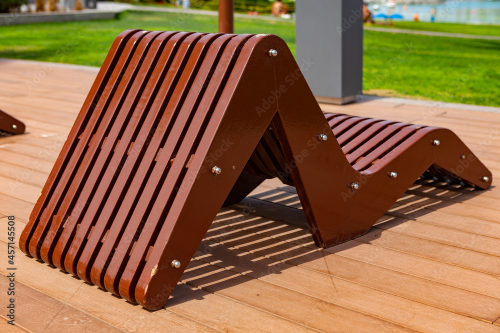 Wooden sun chair on deck at luxury resort Wooden sun chair on deck at luxury resort