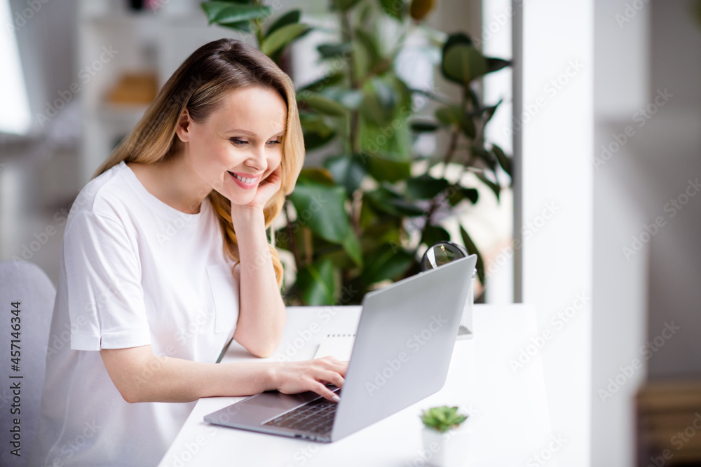 Fototapeta premium Photo portrait woman blonde hair wearing white clothes working from home on computer