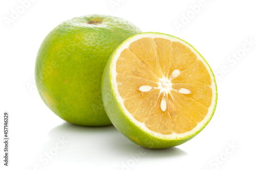 Close-up of Organic Indian Citrus fruit sweet limetta or mosambi (Citrus limetta) with its half cut, it is an green and yellow in color,  isolated over white background, photo