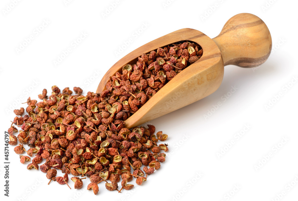 dried Szechuan peppercorns in the wooden scoop, isolated on the white background - obrazy, fototapety, plakaty 