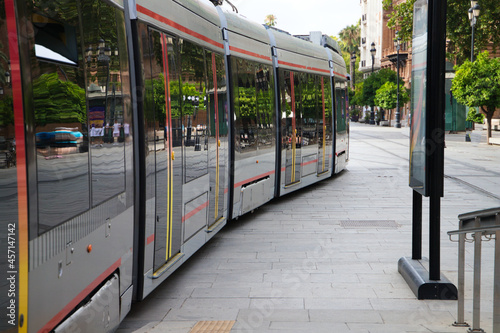 tram arriving at its station to pick up passengers. Travel concept, public transport, renewable energy and non-polluting.