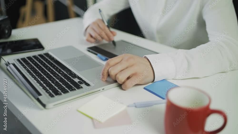 An unrecognizable man draws on a graphic tablet. Remote work. Freelance. Video in motion. Close-up An unrecognizable man draws on a graphic tablet. Remote work. Freelance. Video in motion. Close-up