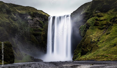 breath taking powerful Skogafoss waterfall  along route 1 in Iceland during summer.