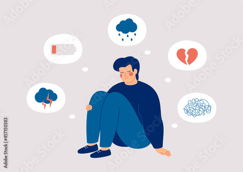 Sad man who suffers from mental health illness is sitting on the floor. Boy surrounded by symptoms of depression disorder: anxiety, crisis, tears, exhaustion, loss,  overworked, tired. Vector photo