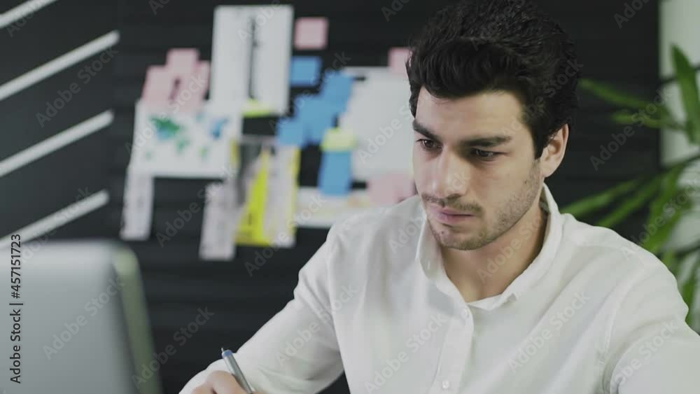 A young man of Caucasian appearance draws on a graphic tablet. Remote work. Freelance. Close-up A young man of Caucasian appearance draws on a graphic tablet. Remote work. Freelance. Close-up