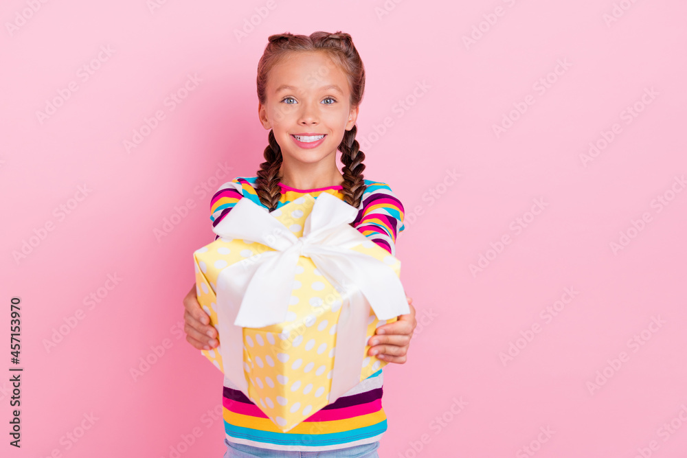 Photo of adorable cheerful guest lady hold gift box give toothy smile wear striped shirt isolated pink color background Photo of adorable cheerful guest lady hold gift box give toothy smile wear striped shirt isolated pink color background