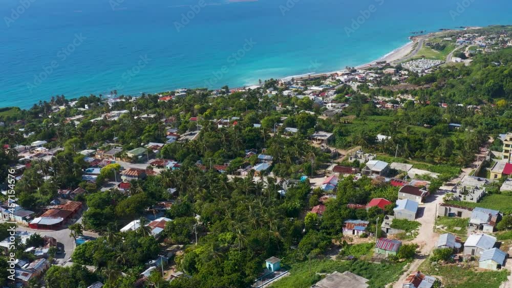 City landscape on the seashore. Beautiful little town on the ocean. Sunny day on the Caribbean coast. Bright blue sea on the white sand of a tropical beach. City and sea. City landscape on the seashore. Beautiful little town on the ocean. Sunny day on the Caribbean coast. Bright blue sea on the white sand of a tropical beach. City and sea.