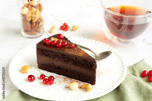 Raw vegan chocolate cake on light grey background