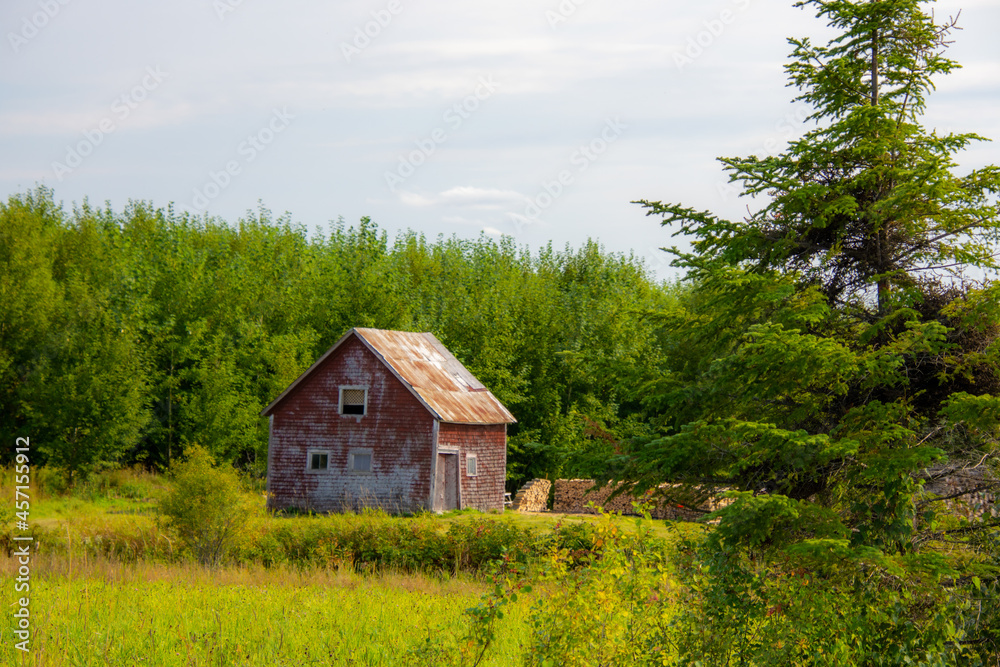 Old barn on a farm in the canadian countryside in Quebec	