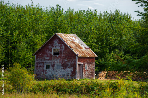 Old barn on a farm in the canadian countryside in Quebec 