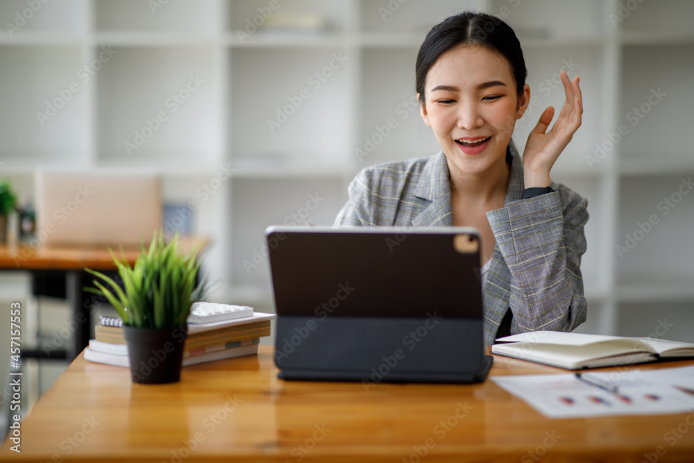 Portrait of Asian young Business woman in having a video call on laptop. Portrait of Asian young Business woman in having a video call on laptop.