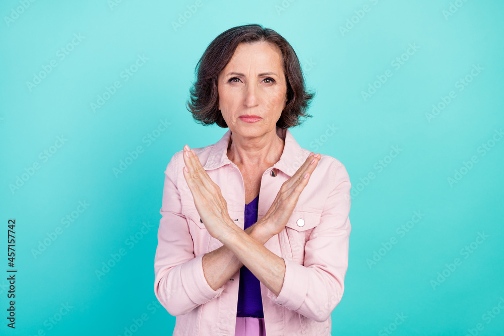 Photo portrait woman in casual clothes showing protest crossed hands isolated bright turquoise color background Photo portrait woman in casual clothes showing protest crossed hands isolated bright turquoise color background