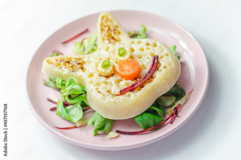 Funny and nice bunny shaped crumpets served with mix fresh vegetables, funny food for kids Funny and nice bunny shaped crumpets served with mix fresh vegetables, funny food for kids