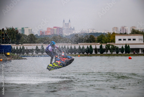 competition and freestyle in the program of competitions on aquabikes in open water on the lake  photo