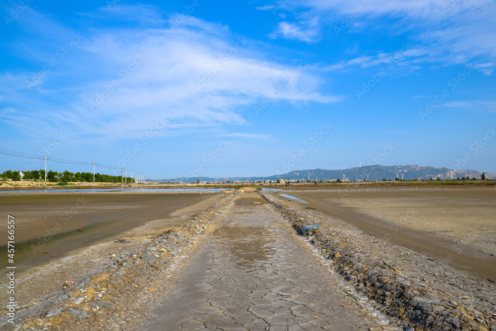 Naklejka premium A road piled up on saline alkali land, a salt pond