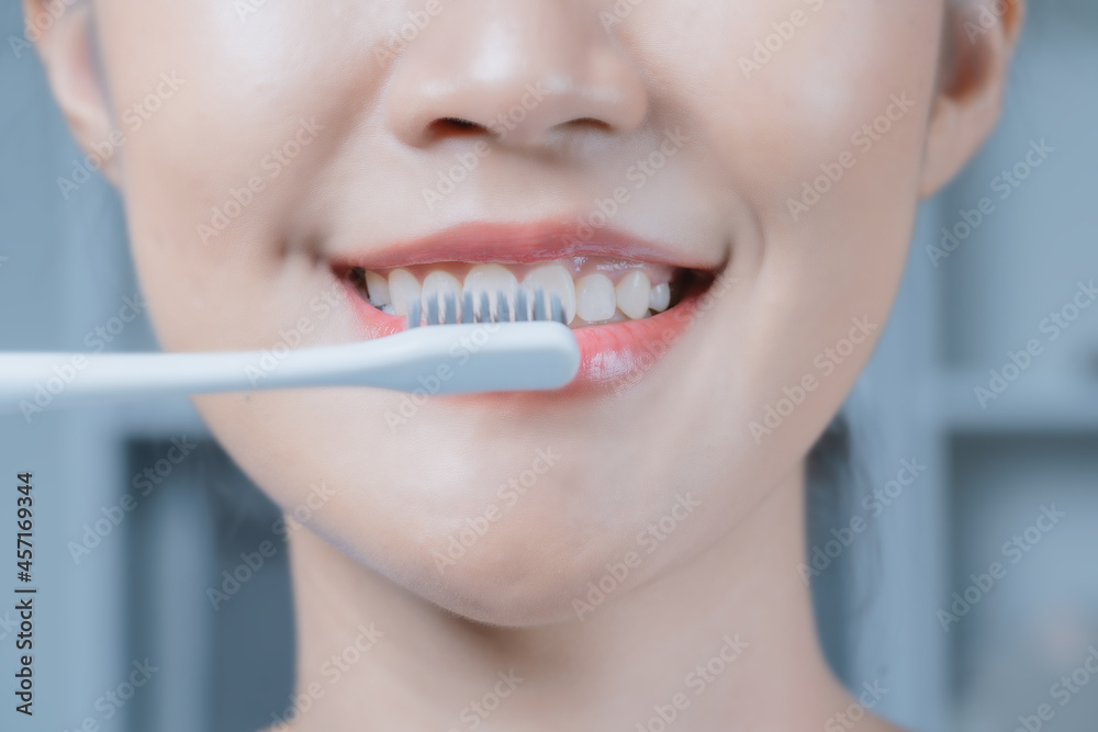 Naklejka premium A woman brushing her teeth.Oral and dental health.