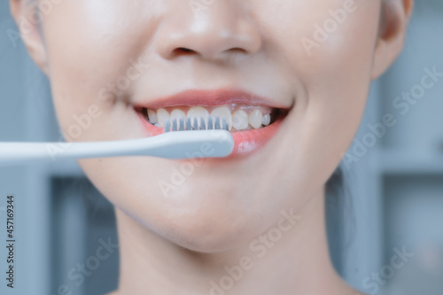 A woman brushing her teeth.Oral and dental health.