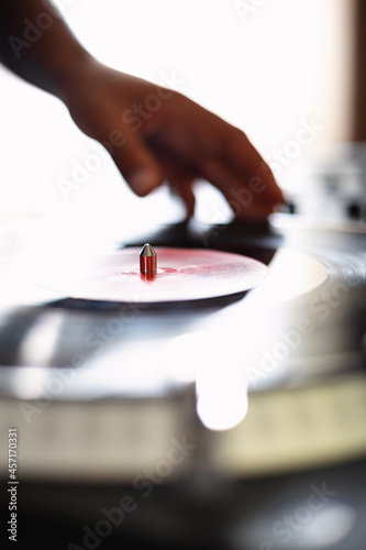 Turntable and dj hand on background. Disc jockey turn table player device with vinyl record disc